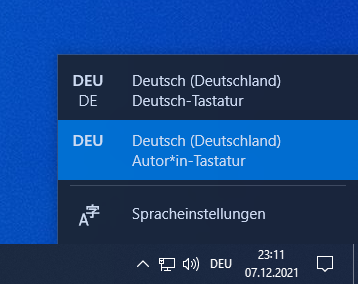 Auswahlbox in der Taskleiste, zu sehen ist sowohl das deutsche Standardlayout als auch Deutsch-Autor